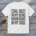 White t-shirt with grey distressed text reading COAL DUST IN MY VEINS MOUNTAINS IN MY SOUL.