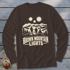 Brown long-sleeve t-shirt with a graphic of three figures, mountains, and the text Brown Mountain Lights.