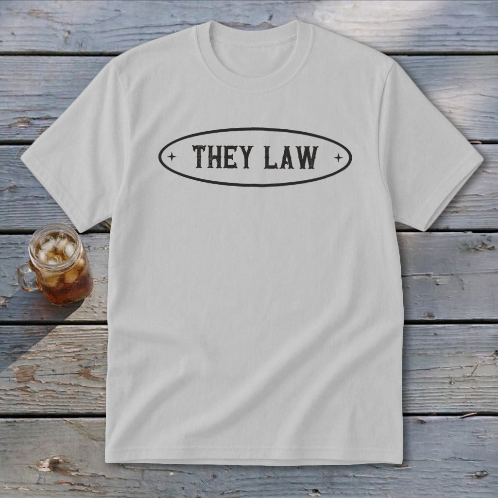 White t-shirt with "THEY LAW" text in an oval emblem.