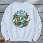 White sweatshirt with a circular graphic depicting a West Virginia landscape with mountains, river, trees, and a deer.