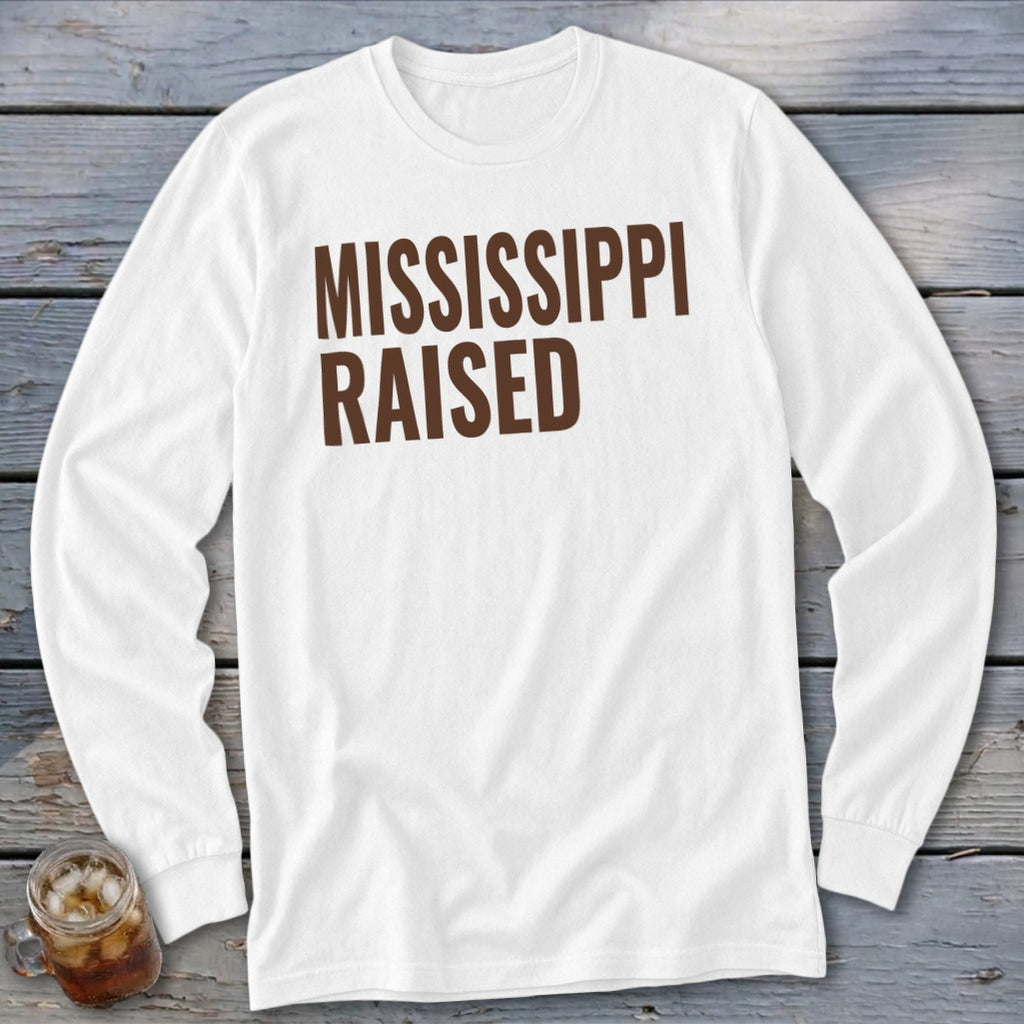 White long-sleeve shirt with brown text that reads "MISSISSIPPI RAISED."