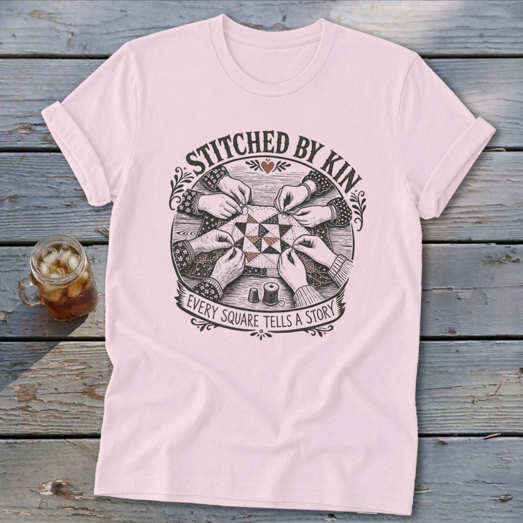 T-shirt with "STITCHED BY KIN" and "EVERY SQUARE TELLS A STORY" text.