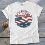 White t-shirt with a circular American flag and mountain graphic.