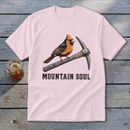Pink t-shirt with a cardinal perched on a pickaxe, text reads "MOUNTAIN SOUL".