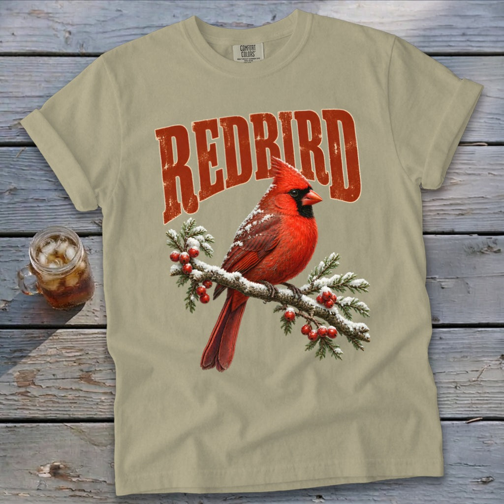 Light olive green t-shirt with a vintage red cardinal and berry branch graphic, featuring the text REDBIRD.