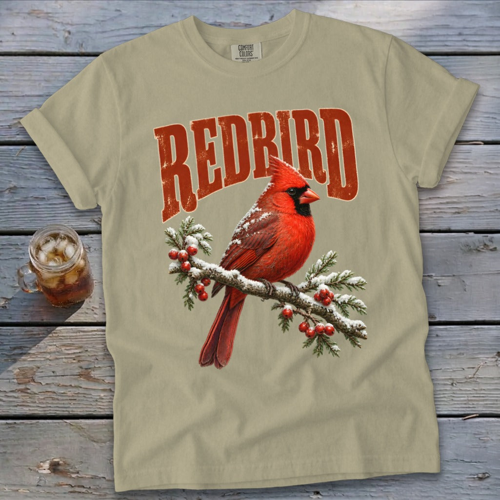 Light olive green t-shirt with a vintage red cardinal and berry branch graphic, featuring the text REDBIRD.