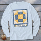 Light blue long-sleeve shirt with a blue and yellow quilt block graphic and "CHURN DASH" text.