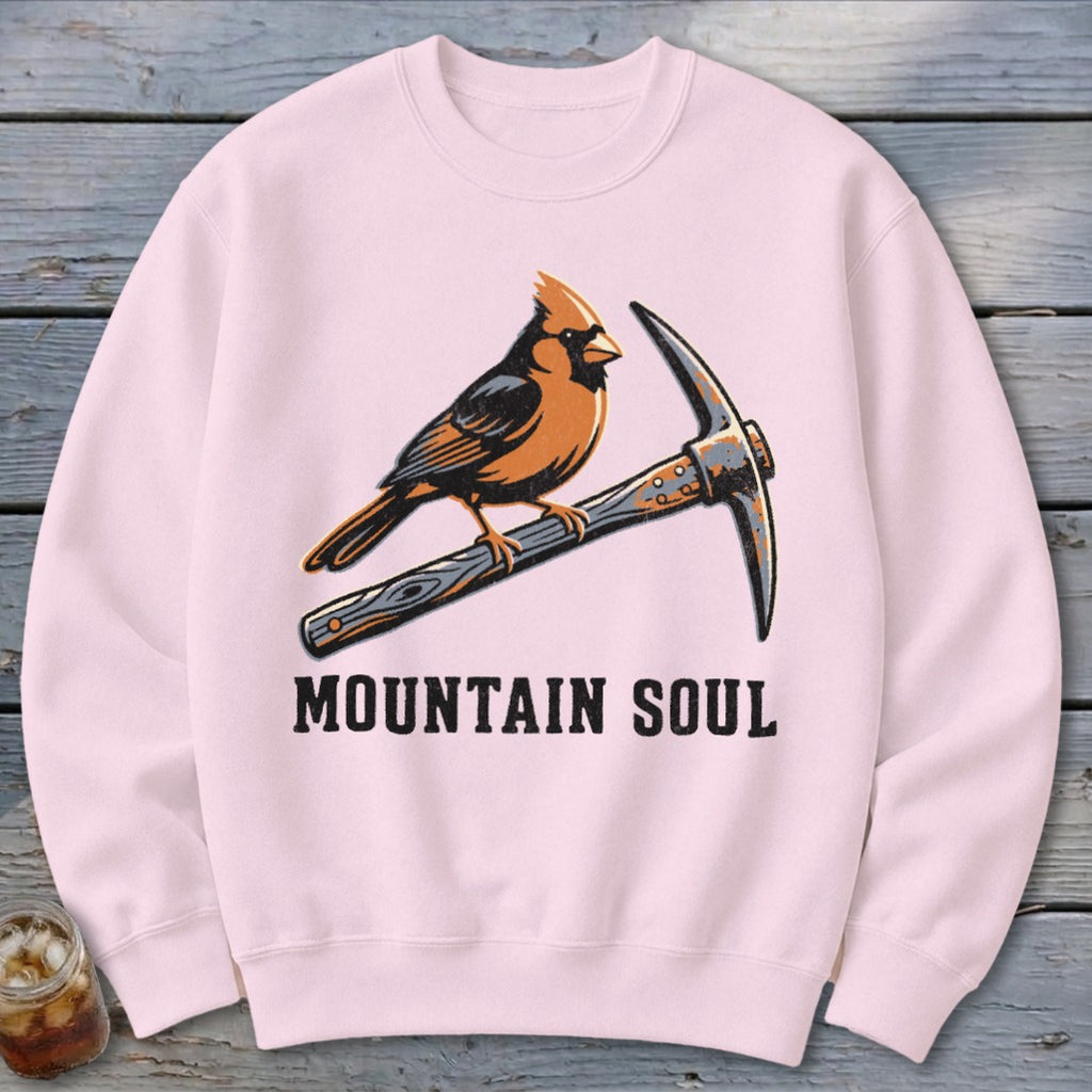 Pink crewneck sweatshirt with a cardinal perched on a pickaxe above the text "MOUNTAIN SOUL".