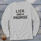 White long-sleeved shirt with black text that reads "LICK AND A PROMISE".