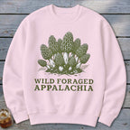 Pink sweatshirt with a green illustration of morel mushrooms and text "WILD FORAGED APPALACHIA".