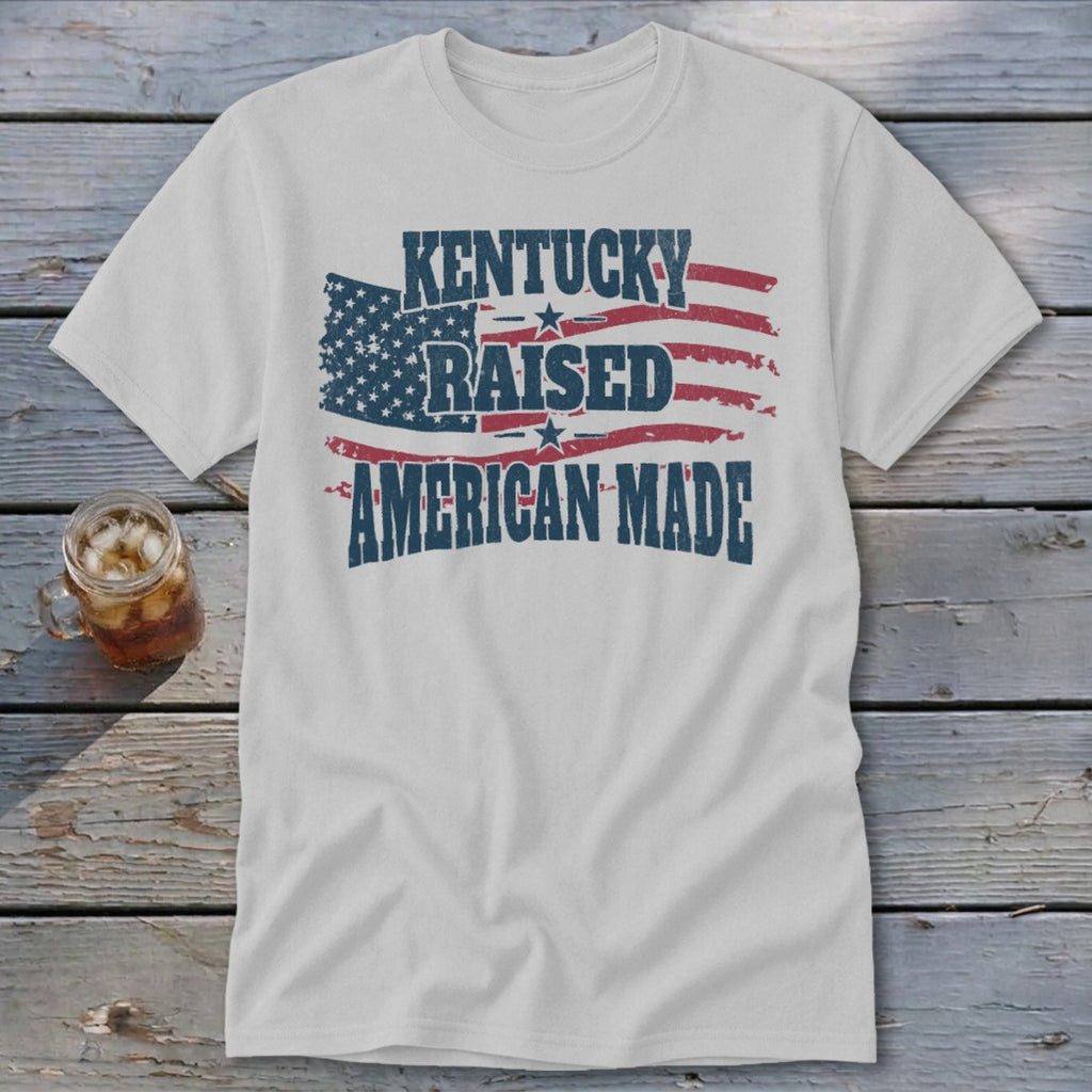 White t-shirt with distressed American flag and text: Kentucky Raised American Made
