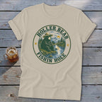 T-shirt graphic of a bear fishing with text "Holler Bear Fishin Hole" in a circle.