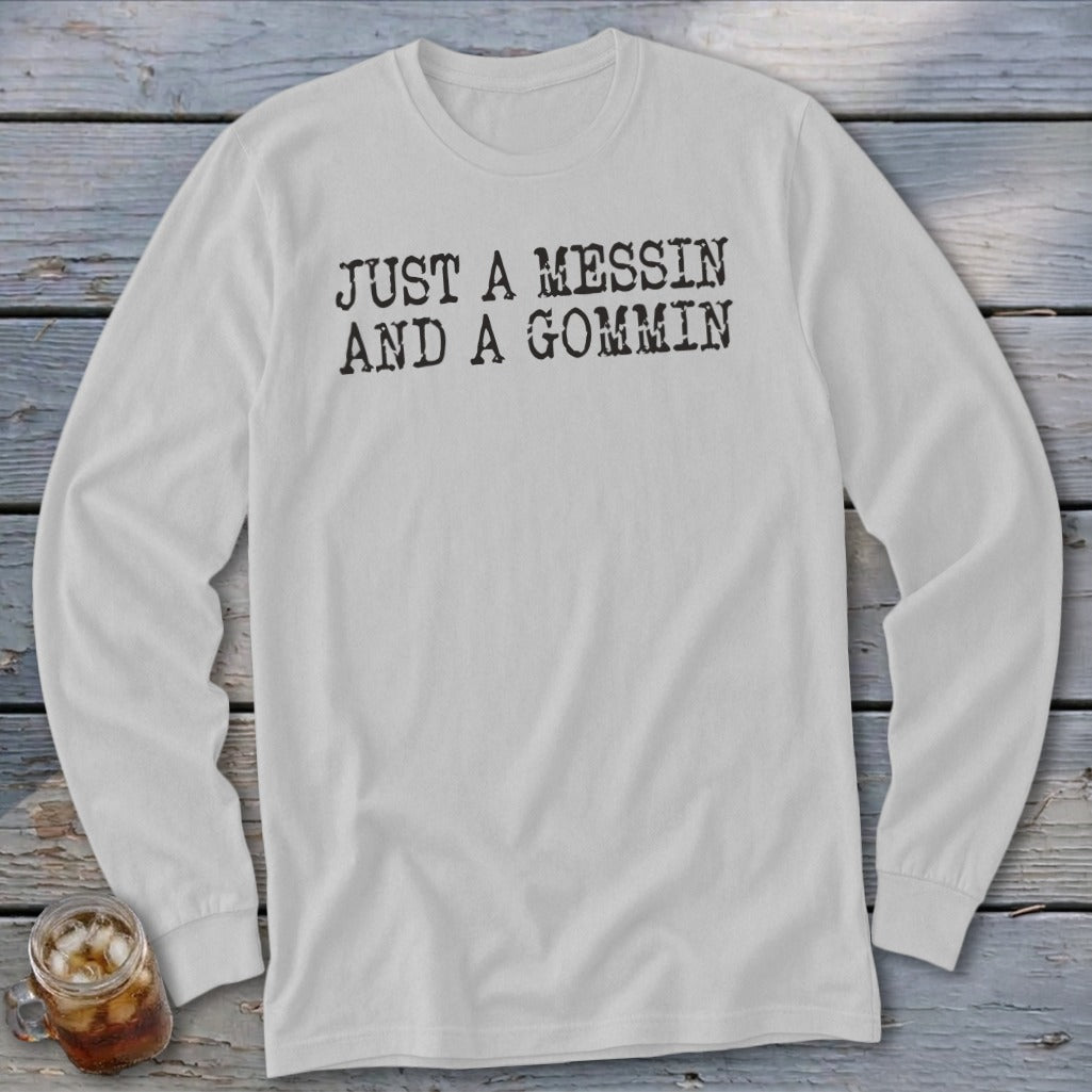 White long-sleeved shirt with black text "JUST A MESSIN AND A GOMMIN".