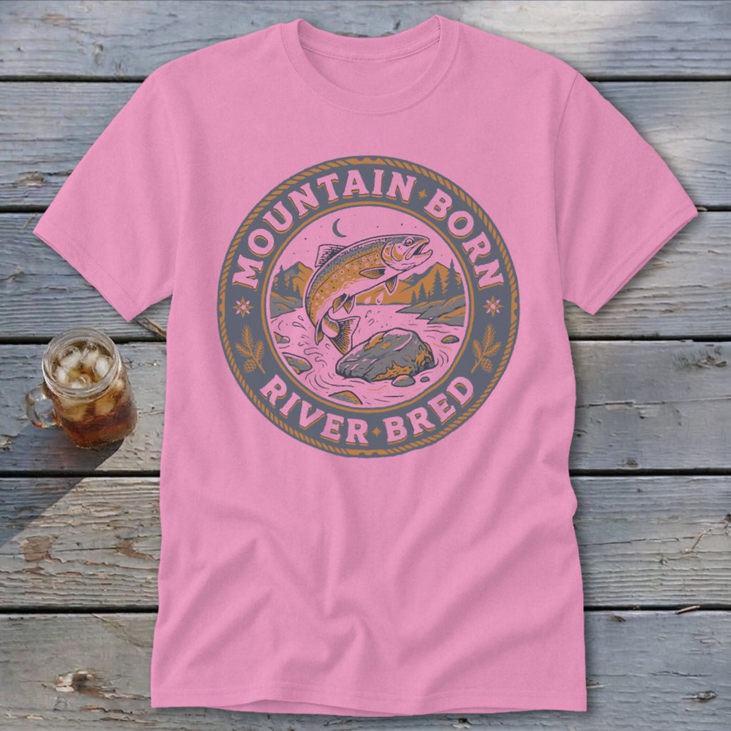 Pink t-shirt with circular graphic of fish jumping in river, mountains, and text.