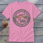 Pink t-shirt with circular graphic of fish jumping in river, mountains, and text.