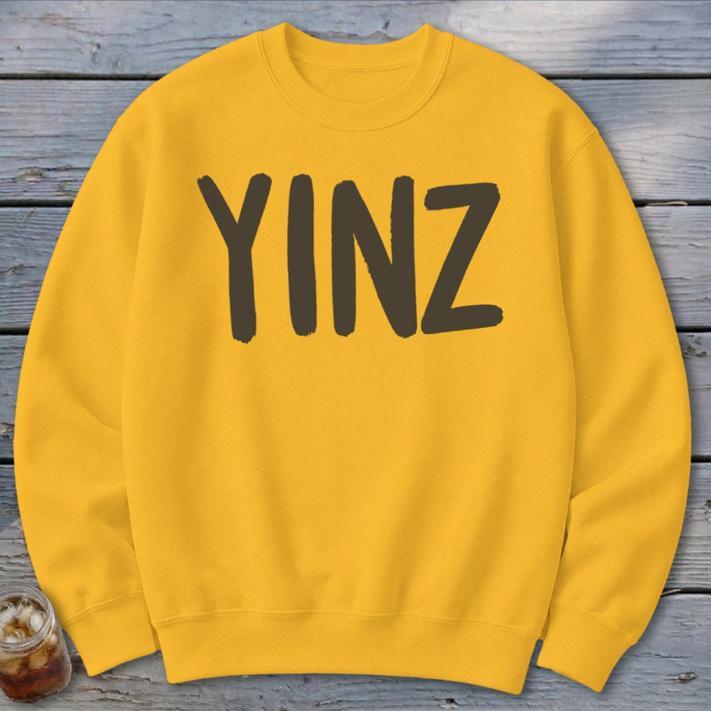 Yellow crewneck sweatshirt with "YINZ" printed in dark brown.