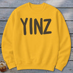 Yellow crewneck sweatshirt with "YINZ" printed in dark brown.