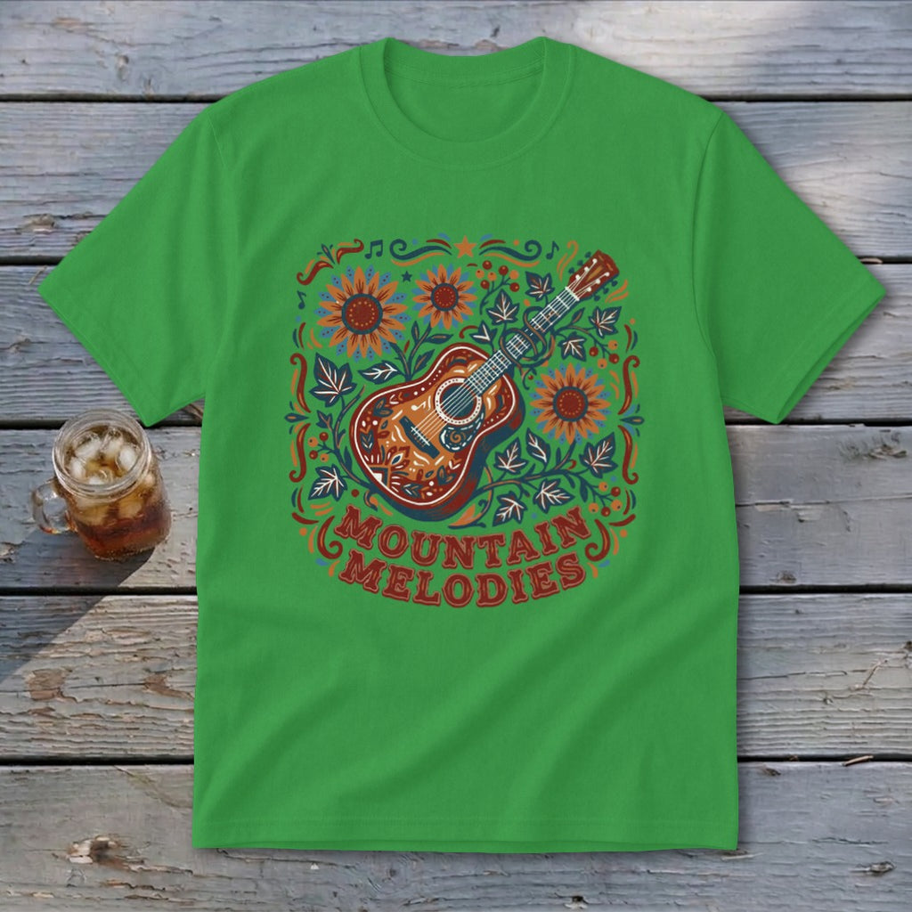 A bright green t-shirt featuring a folk-art acoustic guitar graphic surrounded by sunflowers and the text "Mountain Melodies".