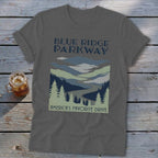 Dark grey t-shirt featuring a Blue Ridge Parkway graphic with mountains, winding road, and pine trees.
