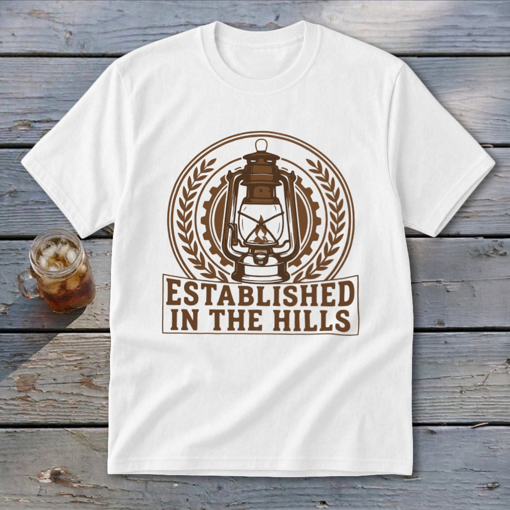 White t-shirt with brown graphic of a lantern and text "Established in the Hills."