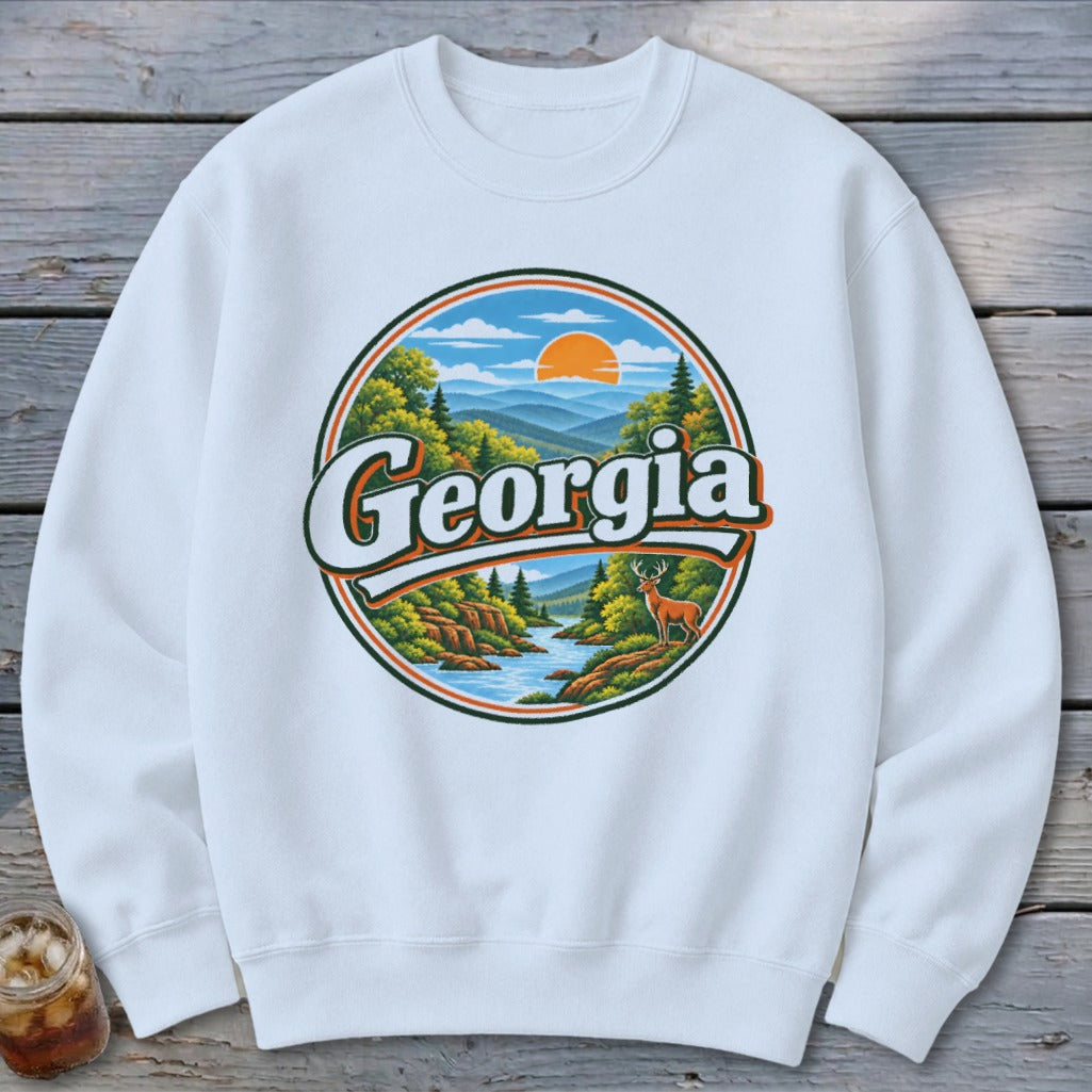 White sweatshirt with a circular graphic of a Georgia landscape with a deer.