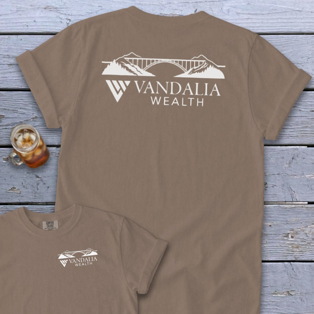 Taupe t-shirt with white Vandalia Wealth logo featuring a bridge and mountains.