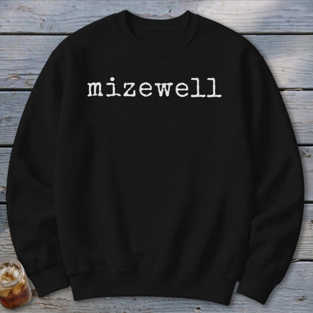 Black sweatshirt with white "mizewell" text in typewriter font.