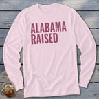 Pink long sleeve shirt with "ALABAMA RAISED" in dark pink text.