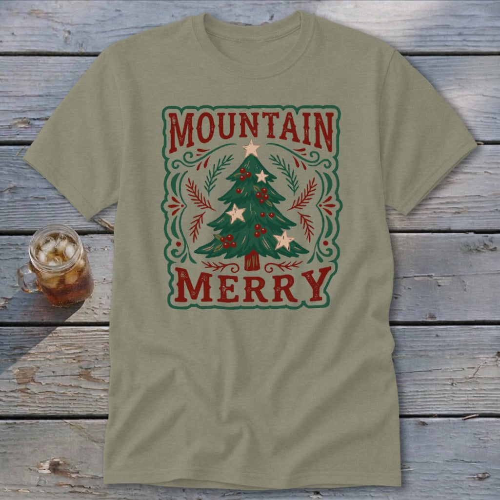 An olive green t-shirt featuring a vintage holiday design with a Christmas tree and the text Mountain Merry.