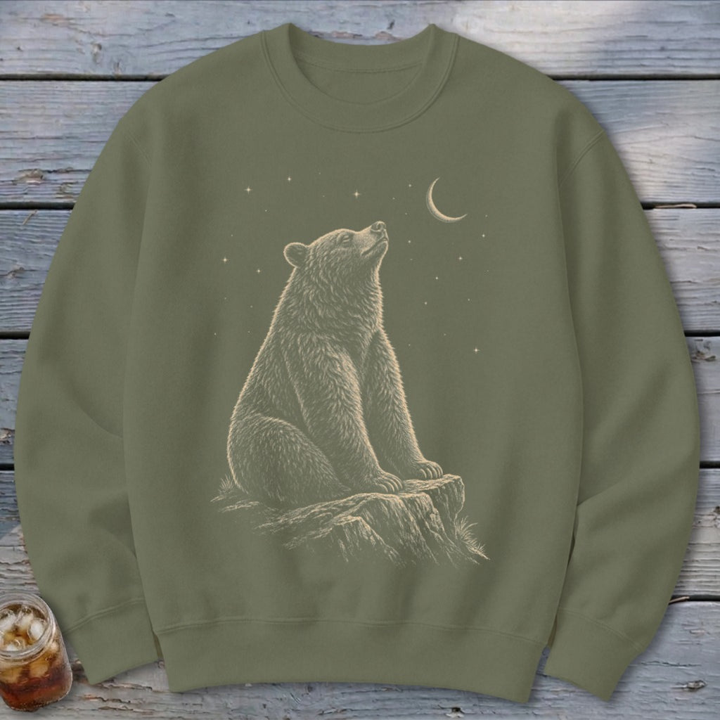 Olive green sweatshirt with a bear sitting on a rock looking at the night sky.