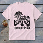Pink t-shirt with black graphic of a farmhouse, trees, fence, and text "OLD HOME PLACE".
