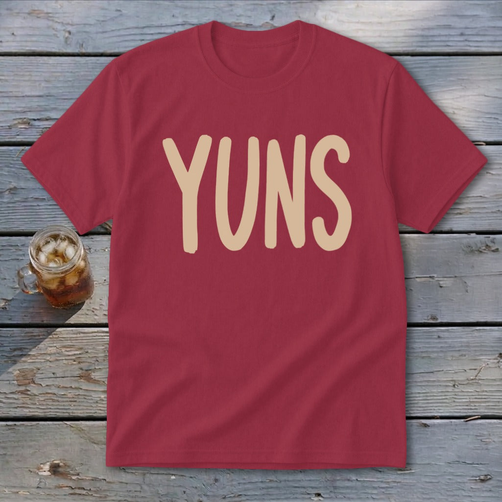 Maroon t-shirt with beige "YUNS" text and glass of iced drink.