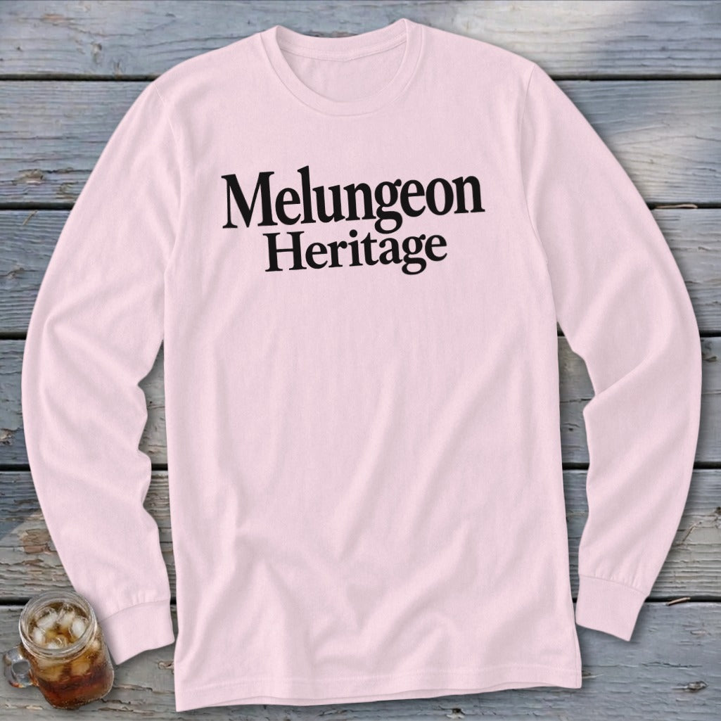 A long-sleeve light pink t-shirt with black text that reads "Melungeon Heritage" on the chest.