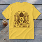 Yellow t-shirt with a brown lantern emblem and text "ESTABLISHED IN THE HILLS".