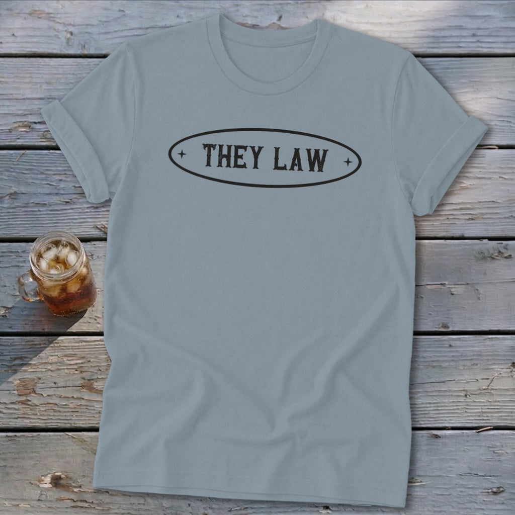 Light blue t-shirt with "THEY LAW" text in an oval emblem.