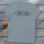 Light blue t-shirt with "THEY LAW" text in an oval emblem.