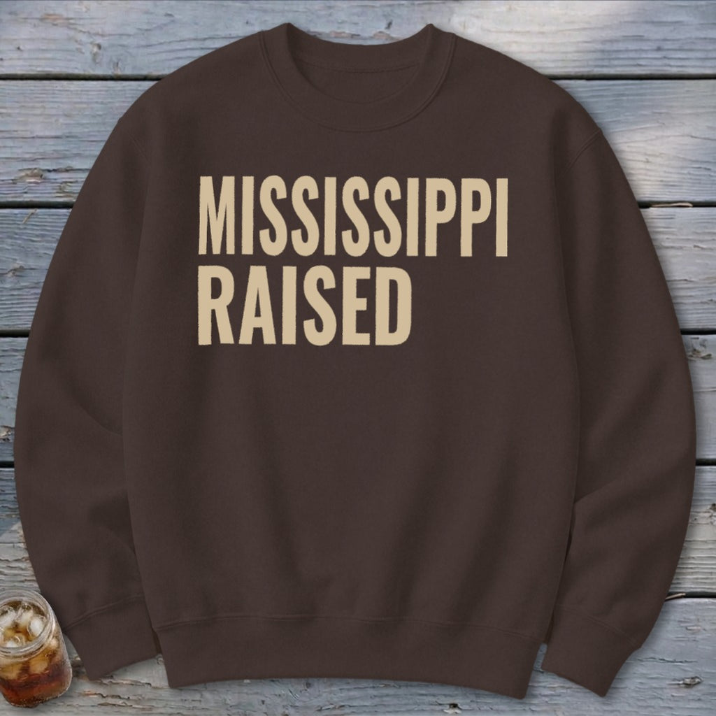 Brown sweatshirt with "MISSISSIPPI RAISED" printed in cream.