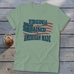 Light green t-shirt with distressed American flag design and text "Virginia Raised American Made."