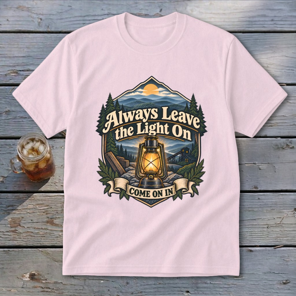 Pink t-shirt with "Always Leave the Light On Come On In" graphic and a lantern.
