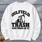 White sweatshirt with black text and oil rig graphic: "Oilfield Trash And Proud Of It".