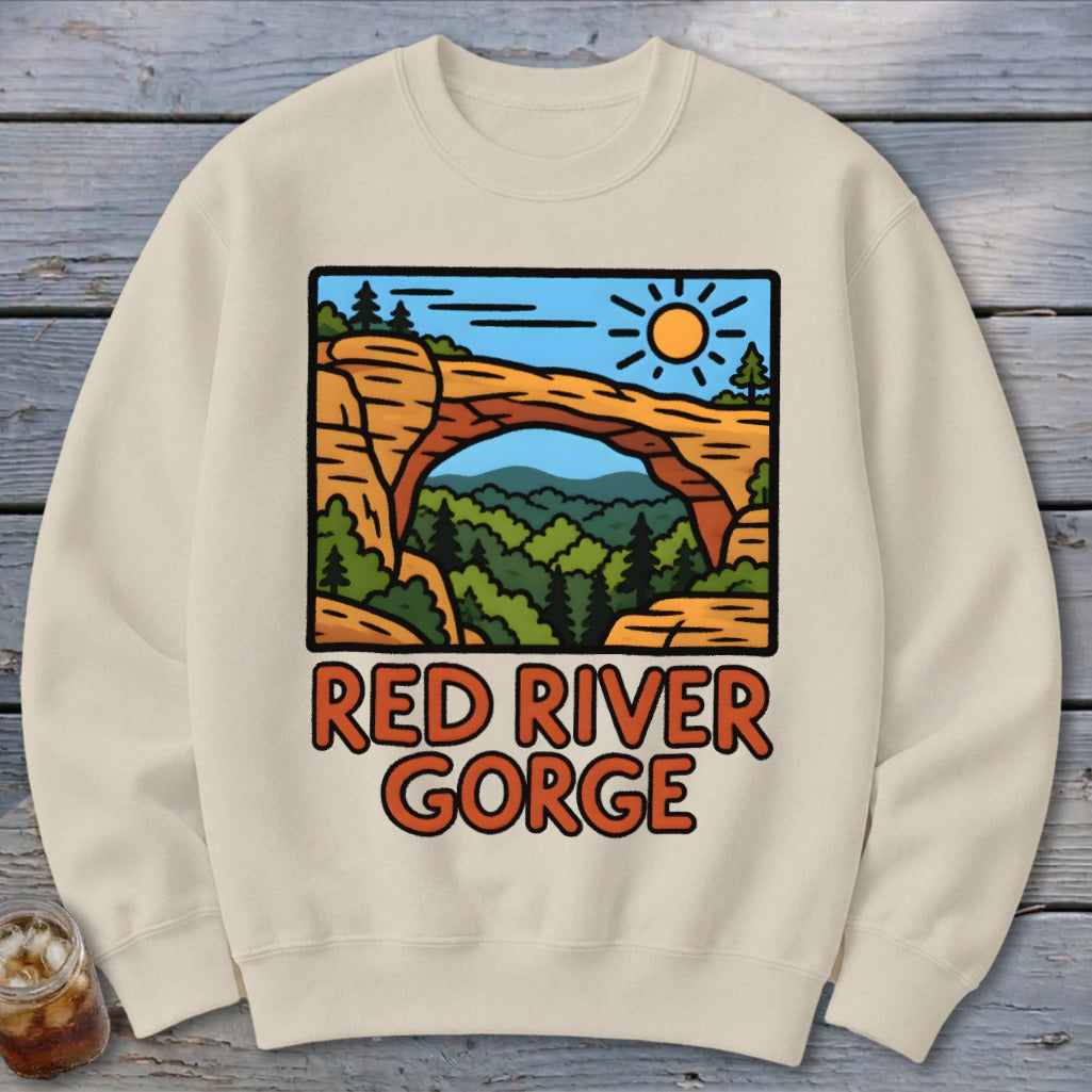 Cream sweatshirt with Red River Gorge graphic featuring a natural arch and forest.