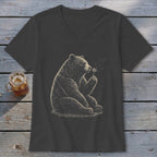 Bear sitting and blowing on a dandelion on a dark grey t-shirt.