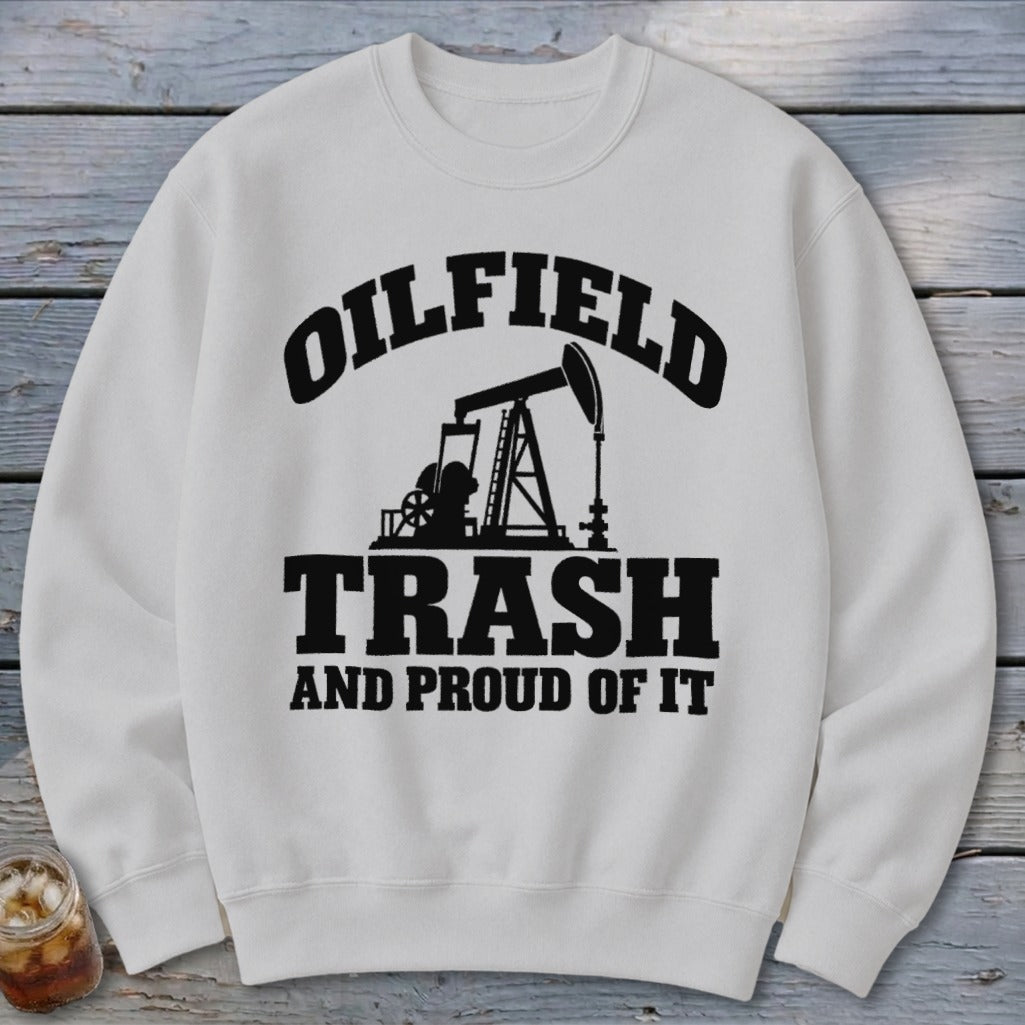 White sweatshirt with black text and oil rig graphic: "OILFIELD TRASH AND PROUD OF IT."