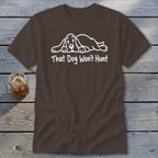 A brown crewneck t-shirt featuring a white line drawing of a sleeping hound dog and the text That Dog Won't Hunt.