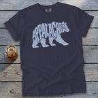 Navy blue t-shirt featuring a light blue bear graphic made of the word Appalachia on a wooden background.