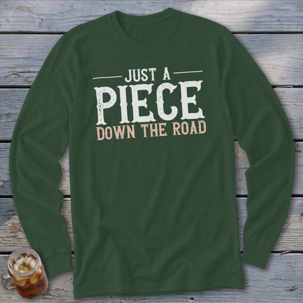 Dark green long-sleeve shirt with "JUST A PIECE DOWN THE ROAD" text.
