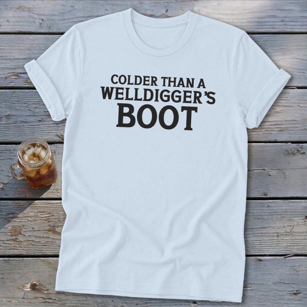 White t-shirt with black text reading "COLDER THAN A WELLDIGGER'S BOOT".