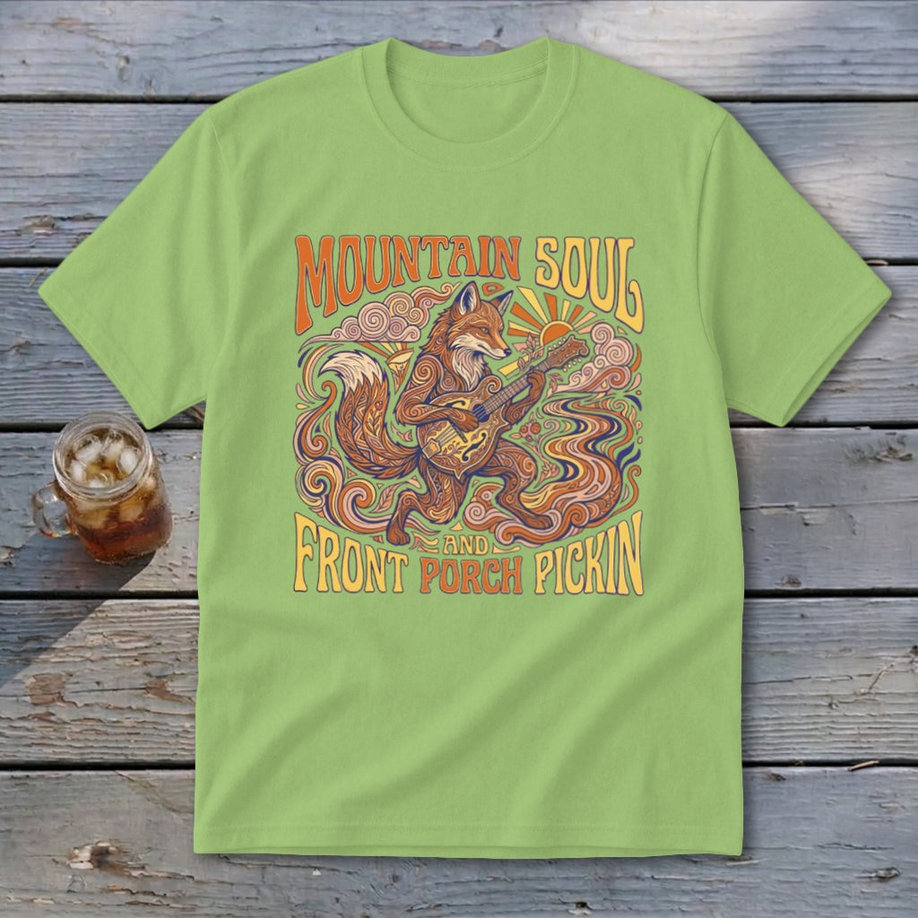 Light green t-shirt with a stylized fox playing guitar and text "Mountain Soul and Front Porch Pickin".