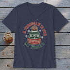 A dark blue V-neck t-shirt with a graphic of a winter hat and the text "A toboggan is for my noggan".