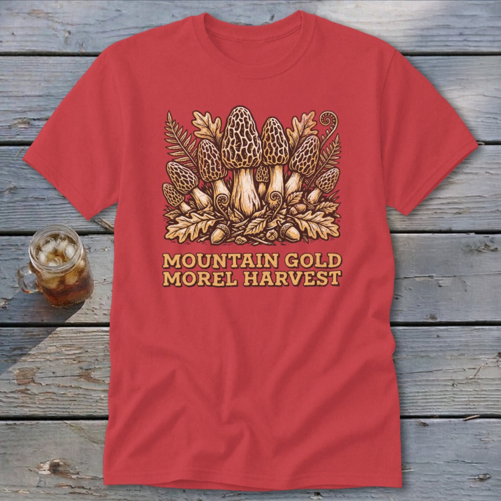 Red t-shirt with morel mushrooms, acorns, oak leaves, and fern graphic. Text says "MOUNTAIN GOLD MOREL HARVEST".
